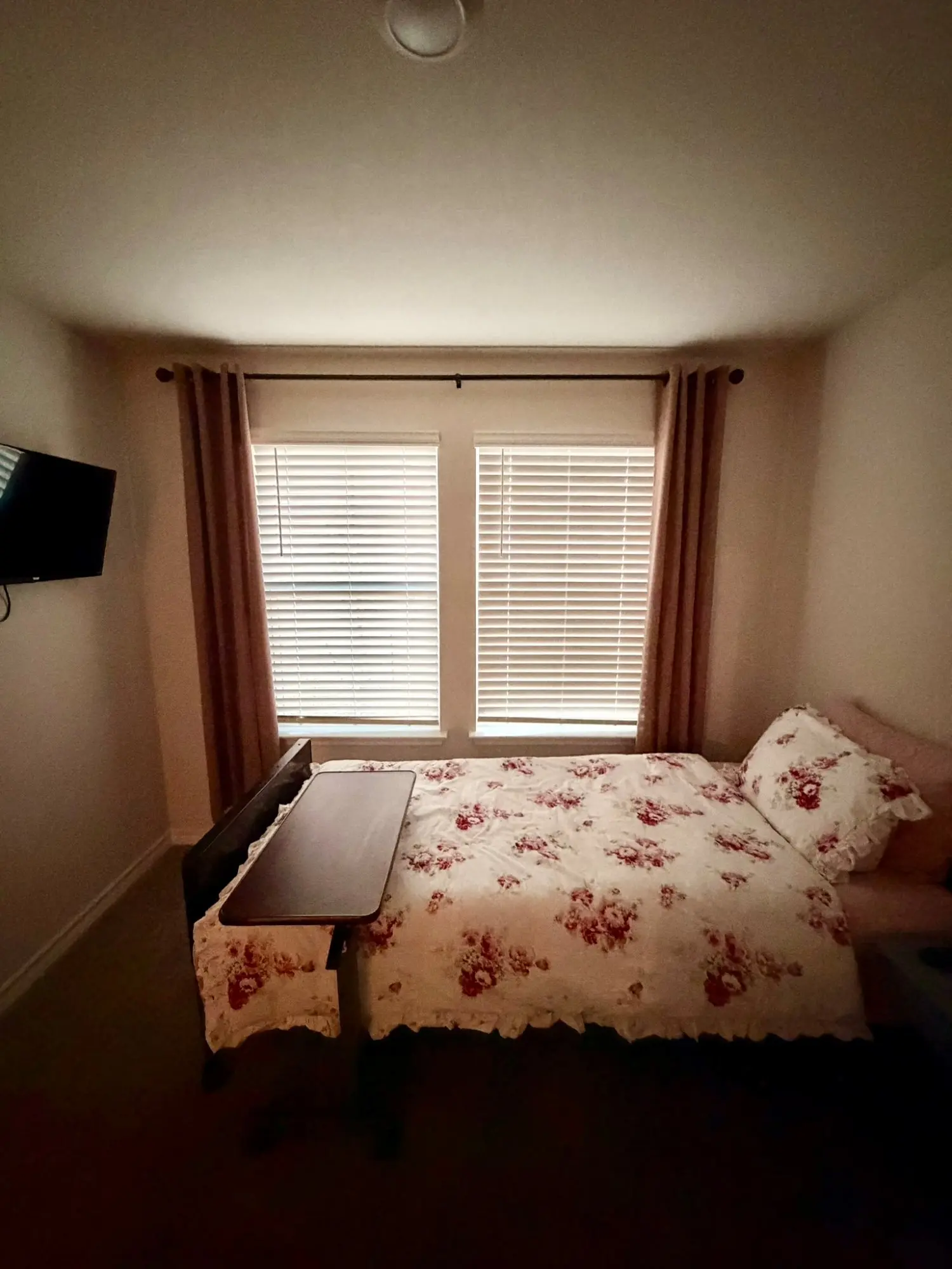 Comfortable resident bedroom with TV and natural light